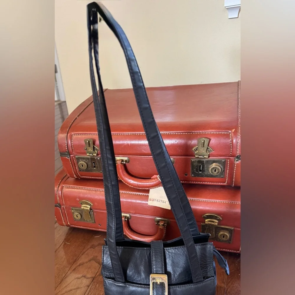 Laura Scott Black shoulder bag with front and back outer pockets, snap closure.